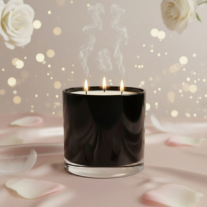 Black candle with two flames on a soft pink background with white roses and petals.