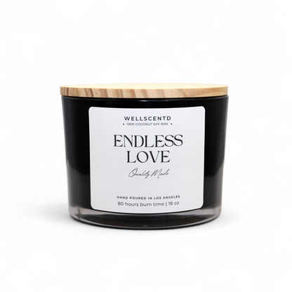 Black candle with a wooden lid labeled 'Endless Love' by Wellscentd on a white background
