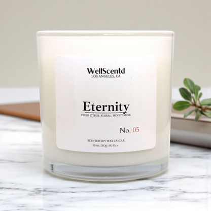 WellScentd 'Eternity' candle on a marble surface with a plant in the background