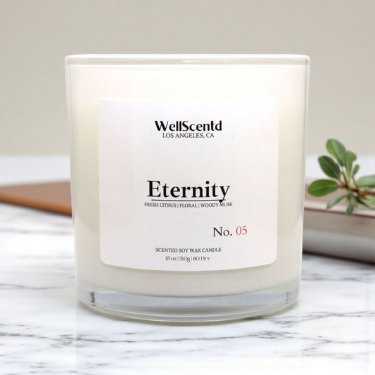 WellScentd 'Eternity' candle on a marble surface with a plant in the background