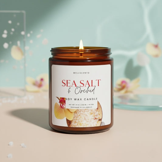 Candle labeled 'Sea Salt & Orchid' in an amber jar with a blurred background