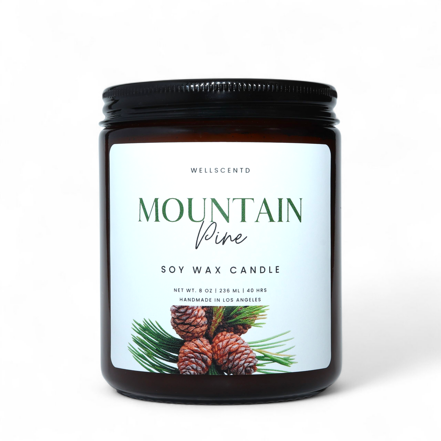 Soy wax candle with 'Mountain Pine' label featuring pinecones and greenery on a white background.