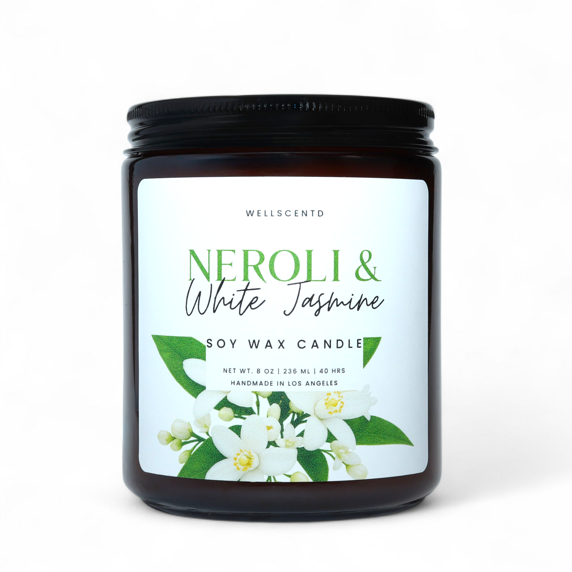 Amber glass Wellscentd Neroli & White Jasmine Candle with green-white label and floral accents on neutral backdrop.