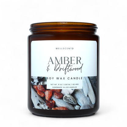 Amber and Driftwood soy wax candle with a label on a white background