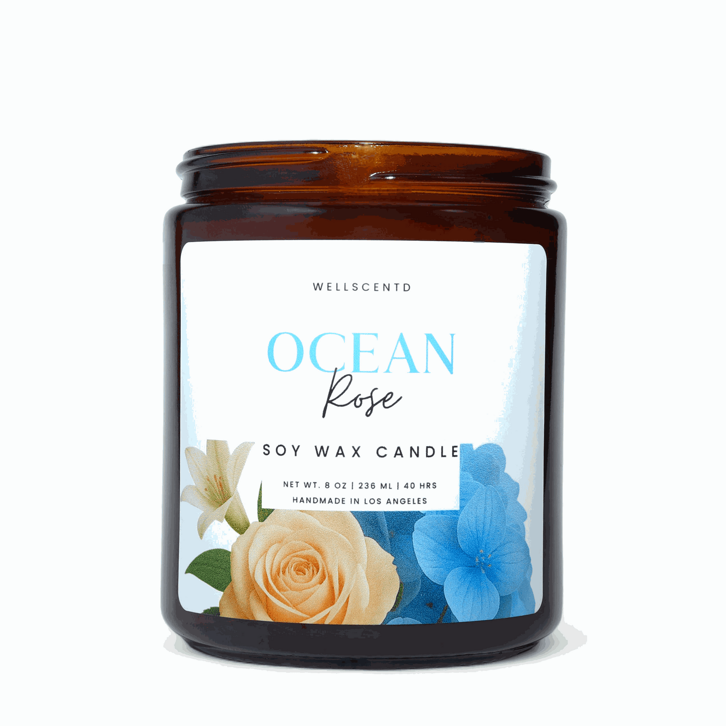 Wellscentd Ocean Rose Candle in an amber glass jar with a blue and gold floral label.