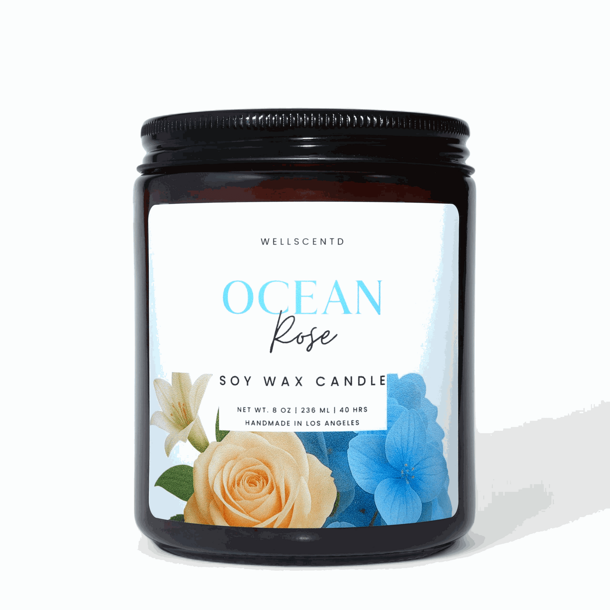 Wellscentd Ocean Rose Candle in an amber jar with black lid.