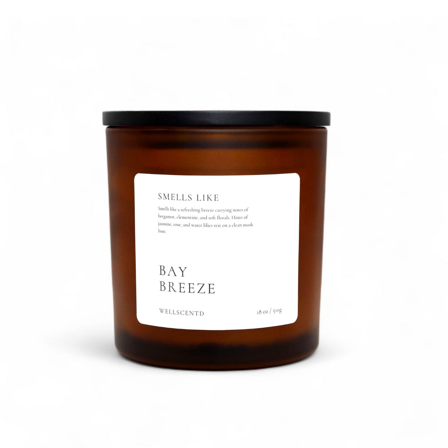 Wellscentd Bay Breeze candle in amber glass jar with black lid – 18oz soy wax, fresh coastal scent, white minimalist label, product photo on white background.