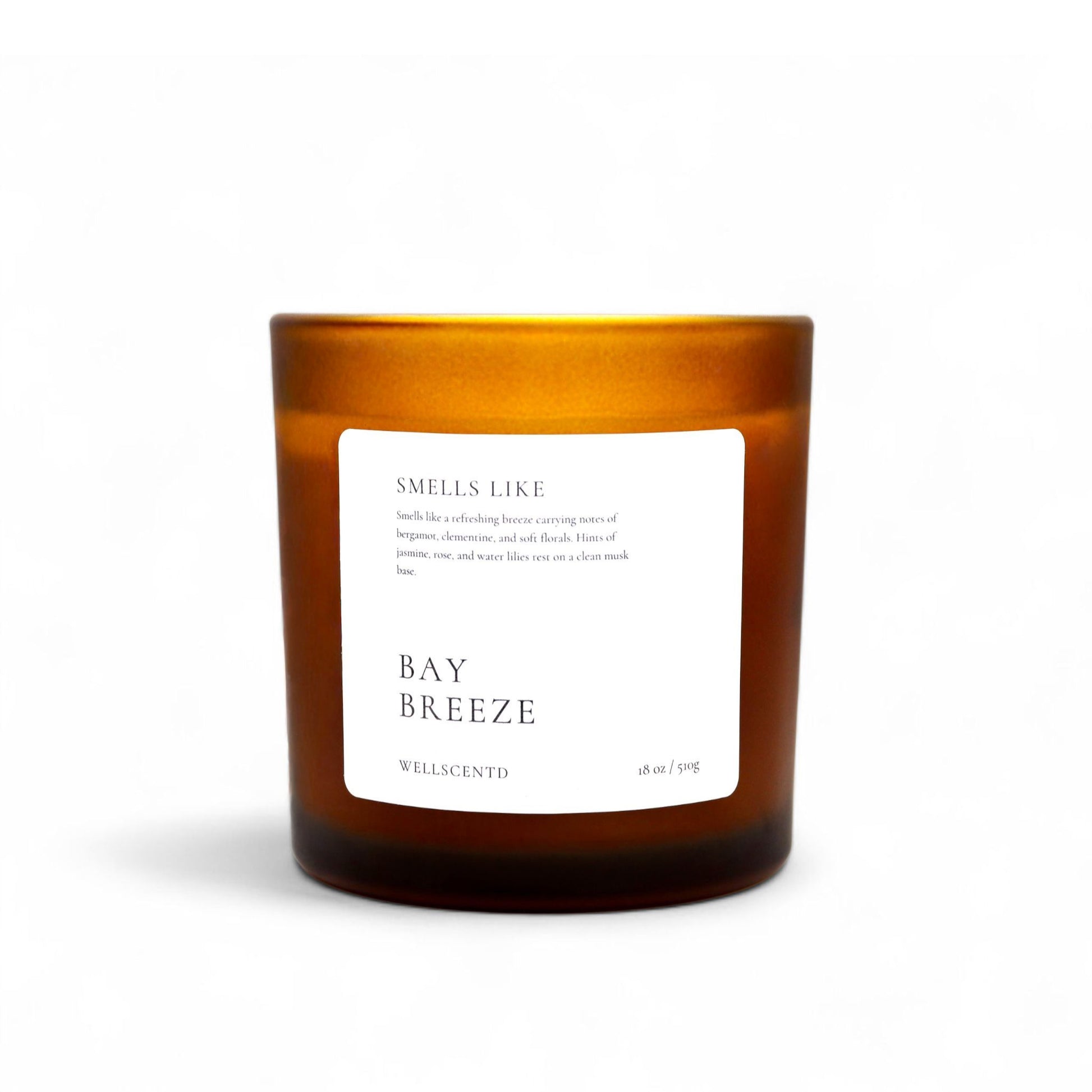 Wellscentd Bay Breeze scented candle in amber glass jar – 18oz soy wax blend, crisp bergamot and water lily fragrance, styled product image on white background.