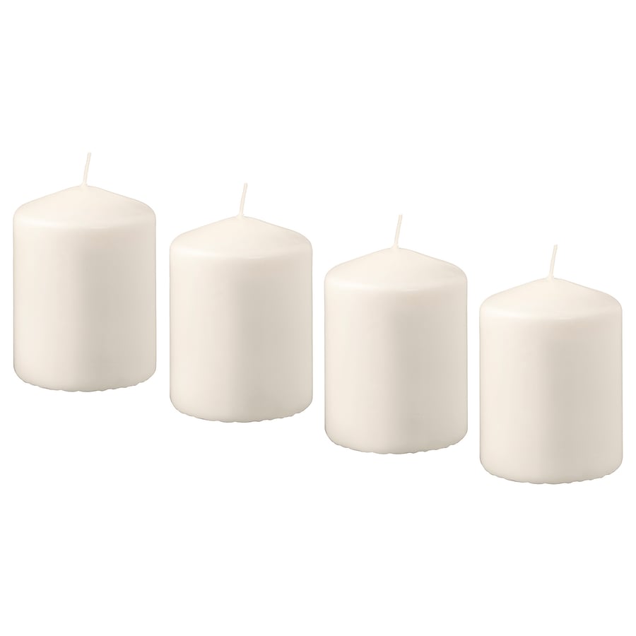 Four white candles on a white background